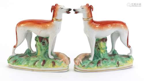 Pair of Staffordshire pottery whippets, each 18cm high : For Condition Reports Please Visit Our