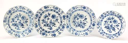 Three Meissen shallow bowls and a plate, each hand painted in the Blue Onion pattern, crossed