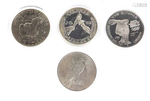 Three American silver dollars with certificates of authenticity and an 1988 Eisenhower dollar :