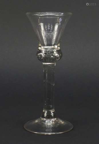 18th century baluster wine glass with trumpet bowl, shoulder knop enclosing tears and basal plain