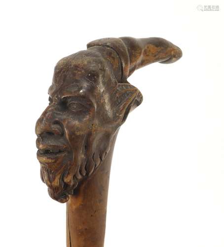 Carved walnut faun's head stick with finger pointer and silver banded collar, 67cm in length : For