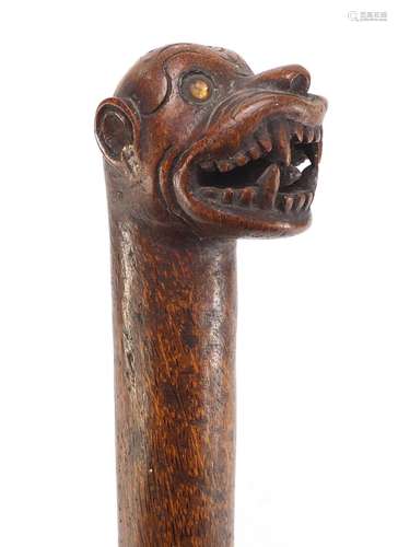 Tribal interest naturalistic walking stick with carved grotesque animal head pommel, 94cm in