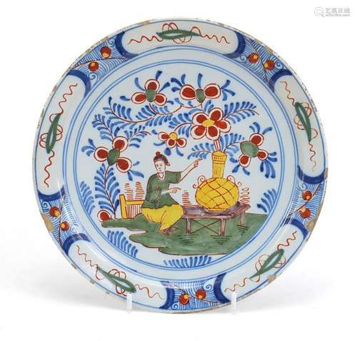 Antique Delft tin glaze pottery plate, hand painted in the chinoiserie manner with a figure and