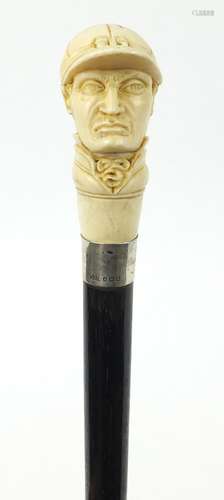 Good ebonised walking stick with carved ivory pommel in the form of jockey Fred Archer, having a