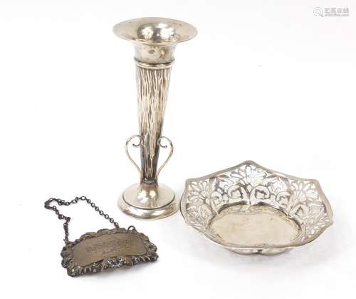 Silver items comprising circular dish with pierced decoration, brandy decanter label and a bud vase,