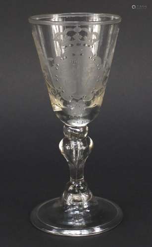 17th/18th century wine glass engraved with a coat of arms, having a baluster stem enclosing a tear
