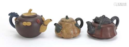 Three Chinese Yixing terracotta teapots including a toad design example, each with impressed