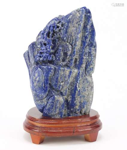 Large Chinese lapis lazuli fragment carved with a figure amongst mountains beside a tree raised on a