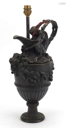 Classical patinated bronze pan design pitcher lamp, decorated in relief with berries and leaves,