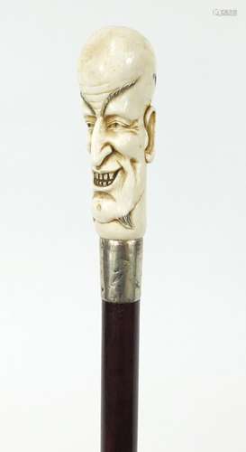 Good snakewood walking stick with carved ivory pommel in the form of a man and ivory ferrule, 94cm