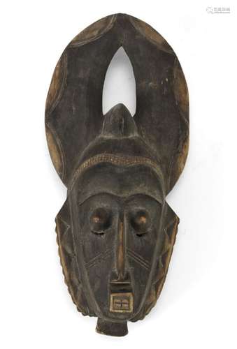 AN AFRICAN CARVED WOOD MASK. BAULÈ CULTURE IVORY COAST EARLY 20TH CENTURY.