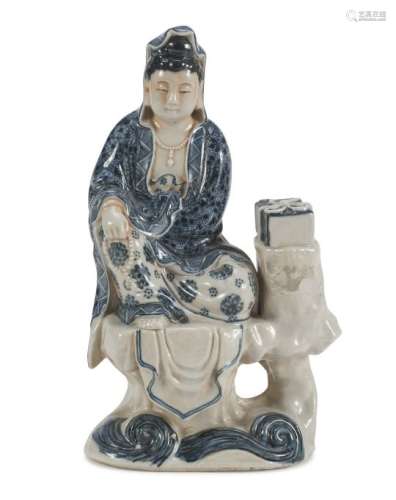 A CHINESE WHITE AND BLUE PORCELAIN SCULPTURE DEPICTING GUANYIN. 20TH CENTURY.