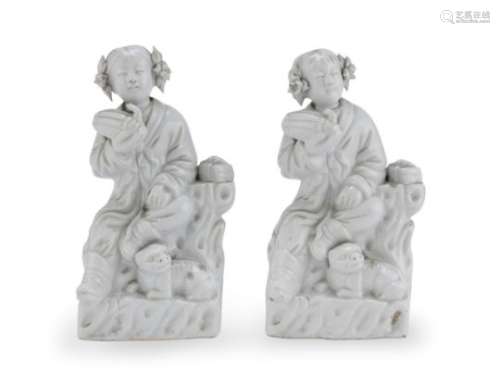 A PAIR OF CHINESE WHITE PORCELAIN GROUPS DEPICTING CHILDREN AND DOGS EARLY 20TH CENTURY
