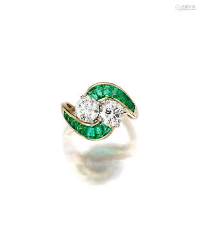 A twin stone diamond and emerald ring