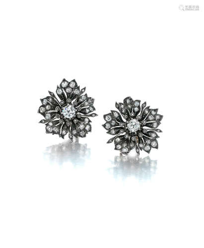 A pair of silver and diamond ear clips