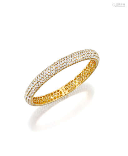 An 18k gold and diamond bangle