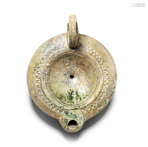 A large Roman lead-glazed pottery oil lamp