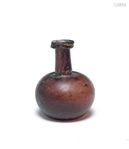 A Roman aubergine glass flask