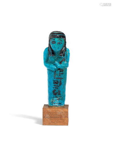 An Egyptian bright blue glazed composition shabti for Wsir-Wer