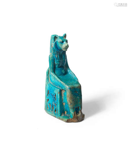 A large Egyptian blue glazed composition seated statuette of Sekhmet