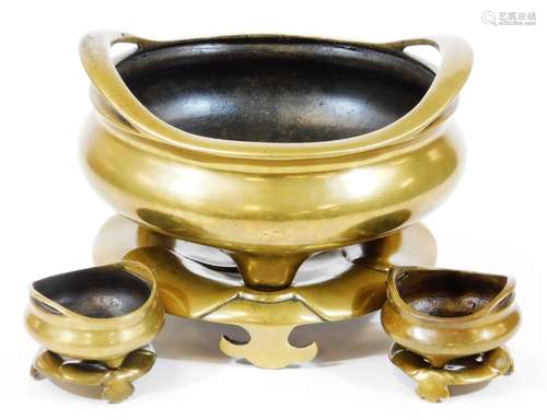 A Chinese bronze tripod censer, of compressed form with loop handles, the base with six character