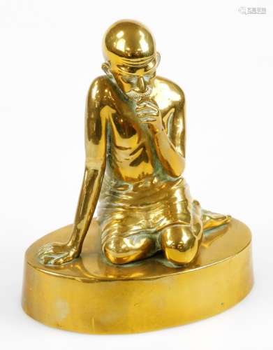 A cast and formed brass figure of Mahatma Gandhi kneeling, 20cm high.
