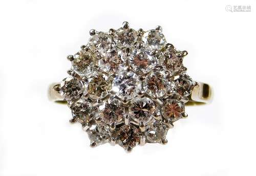 A diamond nineteen stone cluster ring, with three layers of round brilliant cut diamonds, each in