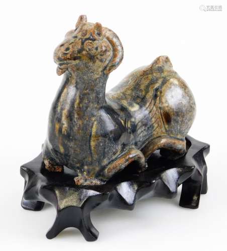 A Chinese pottery water dropper, formed as a horned beast, partially textured in dark glazes,