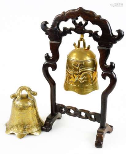 A Chinese brass bell, in a carved hardwood stand, 45cm high, and further bell. (2)