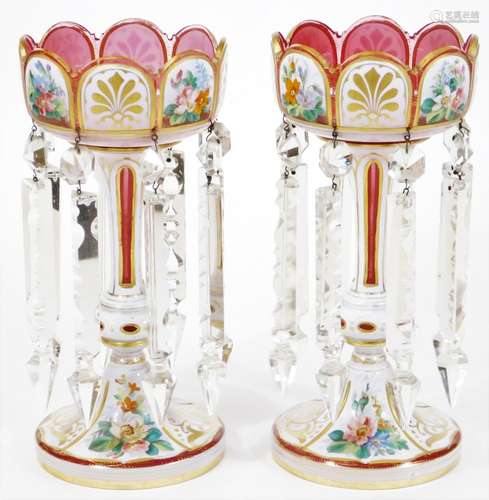 A pair of Victorian Bohemian pink and white overlay glass lustre vases, floral painted and having