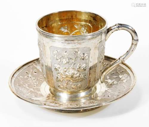 A late 19thC Canton teacup and saucer, each piece repousse decorated with panels of flowers, MK