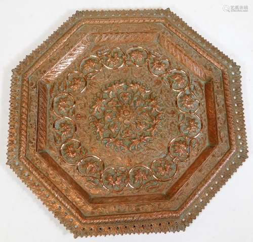 A late 19thC Indian or Burmese octagonal copper plaque, with pierced and raised border, the centre