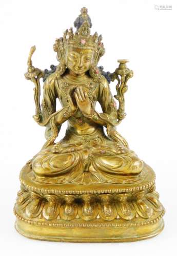 A seated Maitreya Sino-Tibetan gilt bronze figure, with hands gesturing in teaching manner, t