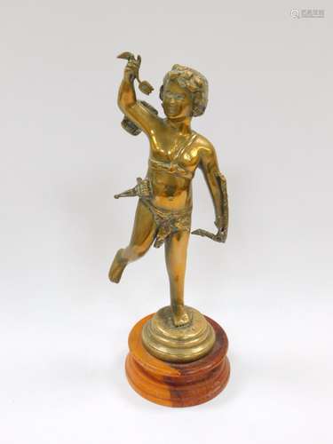 An Italian brass figure of Cupid, modelled standing, raised on a wooden socle, 37cm H.