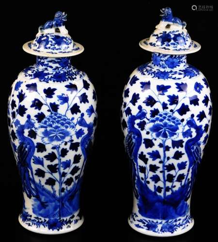 A pair of 19thC Chinese blue and white baluster vases and covers, each with dog of fo finial (1 AF)