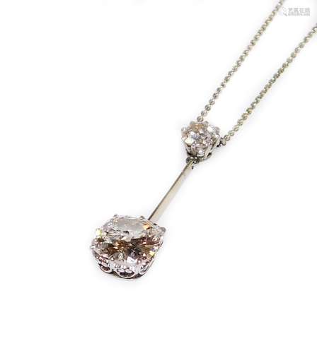 A two diamond drop pendant, the top diamond, round old cut, of 5.2mm (0.4ct) diameter, joined by a