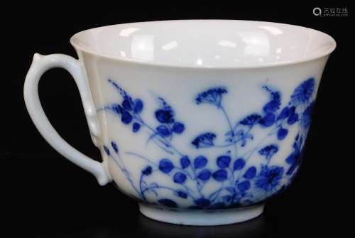 A blue and white porcelain cup, profusely decorated with flowers, on a circular foot, six
