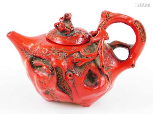 A Chinese teapot, raised with flowers and insects with naturalistic bark handle, plain spout and