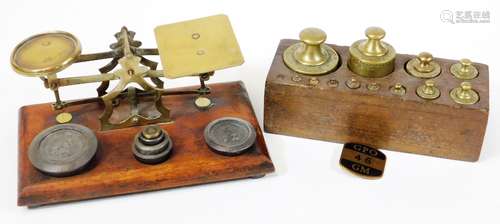 A set of Victorian brass and mahogany postal scales with weights, and a further oak block of