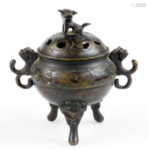 A Chinese bronze censer, with pierced cover having shi-shi finial, scroll lug handles and tripod
