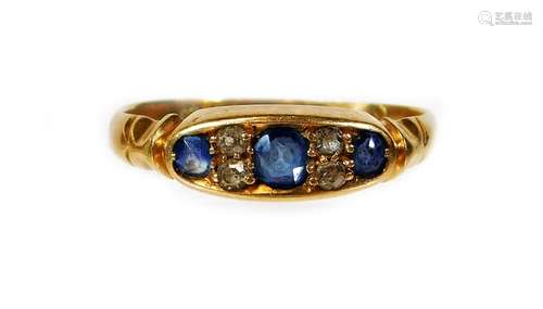 A Victorian 18ct gold sapphire and diamond dress ring, set with three pale blue sapphires and two