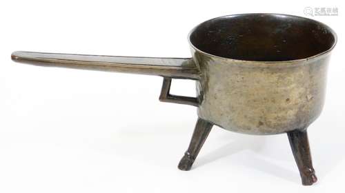 A 17th/18thC bronze posnet or skillet, with taper handles and tripod base, 14cm high, 15cm diameter,