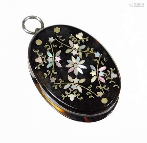 A tortoiseshell and mother of pearl loupe, with flower and leaf design to one side and plain back,