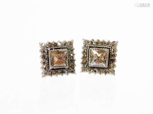 A pair of 9ct gold white gold earrings, each of square design set with central diamond and