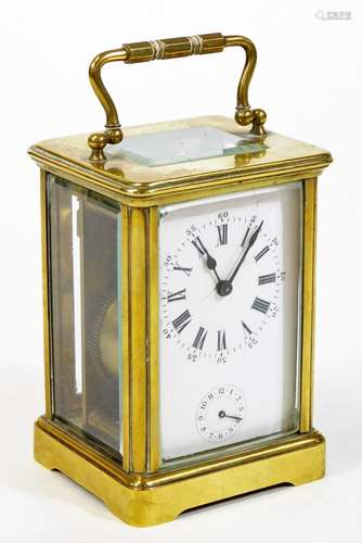 An early 20thC brass carriage clock, of rectangular form, with a five sectional glass case and swing