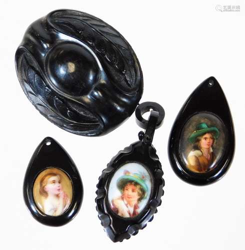 A small selection of jet jewellery, comprising on oval jet leaf brooch, two portrait set pendants