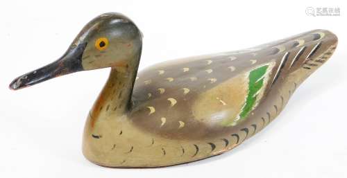 An early 20thC folk art wooden decoy duck, with painted plumage predominantly in green and grey,