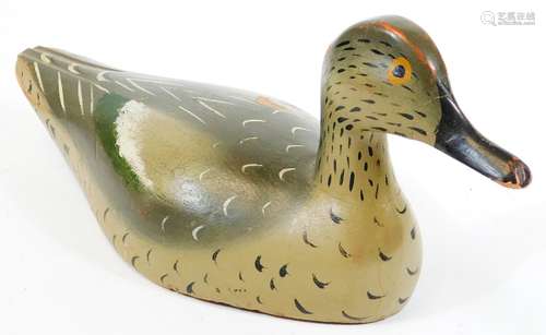 An early 20thC folk art wooden decoy duck, with painted plumage predominantly in green and grey,