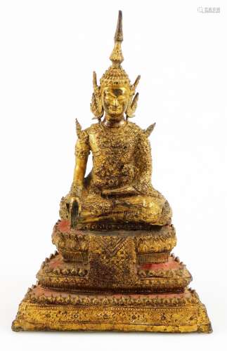 A late 19thC/early 20thC Thai Rattanakosin bronze, on a seated figure, on stepped base partially