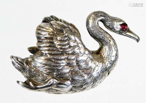 A mid/late 20thC swan brooch, in the form of a seated swan, with red eye, white metal, faint